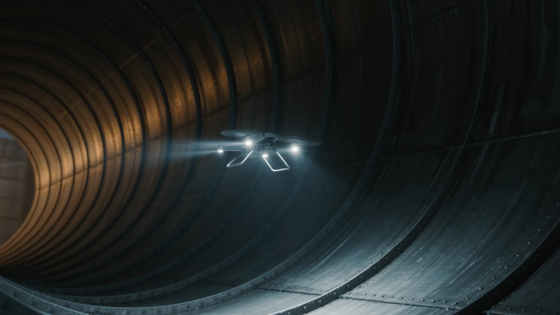 Caged inspection drone hovering inside a large empty steel storage tank